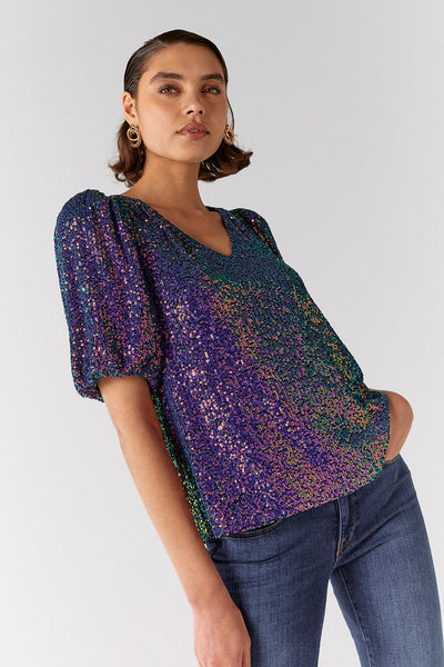 Scamp and Dude Iridescent Puff Sleeve Sequin Top | Model wearing colourful sequin top with blue jeans