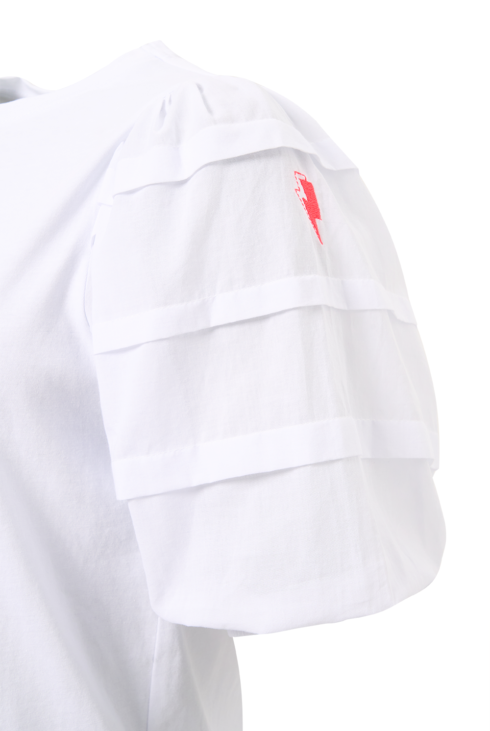 A close-up of a white T-shirt with pintuck detailing on the sleeve and a neon pink embroidered lightning bolt