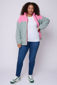 Scamp and Dude Colour Block Fleece Jacket | Model wearing pink and grey fleece jacket with white top and blue jeans