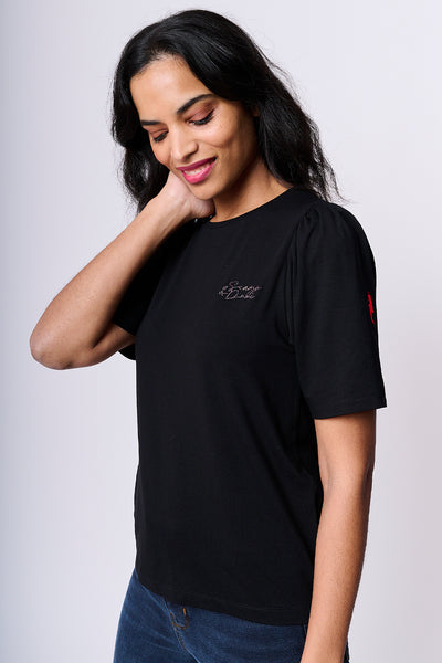 Scamp and Dude Black T-Shirt with Small Logo | Model against white background wearing a black t-shrt and jeans