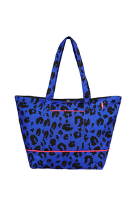 A blue with black leopard and lightning bolt print Weekender bag with neon coral piping detail