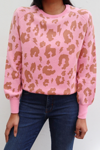 Scamp and Dude Pink with Camel Leopard Knitted Jumper | Close up of model wearing pink leopard jumper with dark denim skinny jeans 