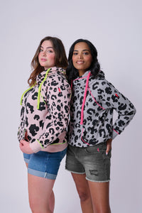 Two women wearing mixed leopard cowl neck hoodies in different colourways
