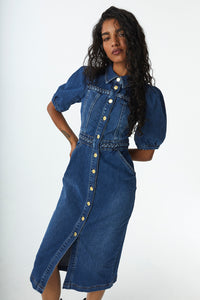 Scamp and Dude Indigo Plait Detail Denim Dress | Model with long curly hair wearing midi length denim dress with hands on hips 