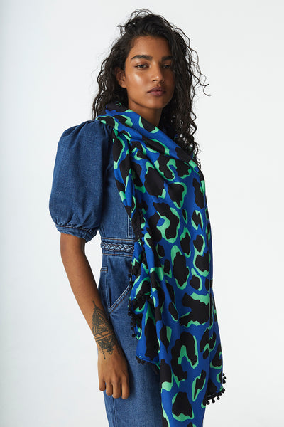 Scamp and Dude Blue and Green Leopard Print Scarf | Model wearing blue and green leopard print scarf with denim jumpsuit