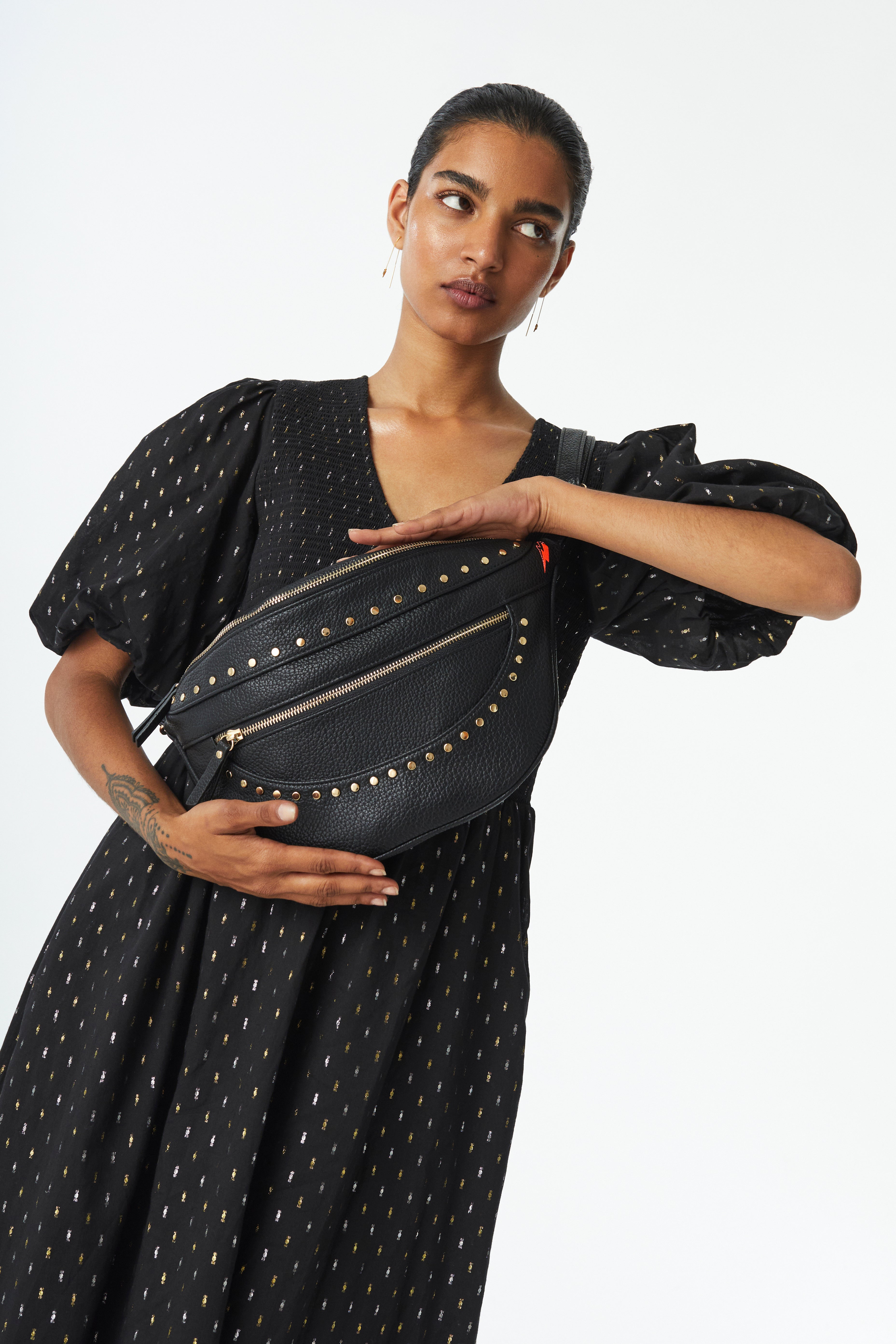 Scamp and Dude Black Studded Bum Bag | Model wearing black studded bum bag across shoulder with black dress 