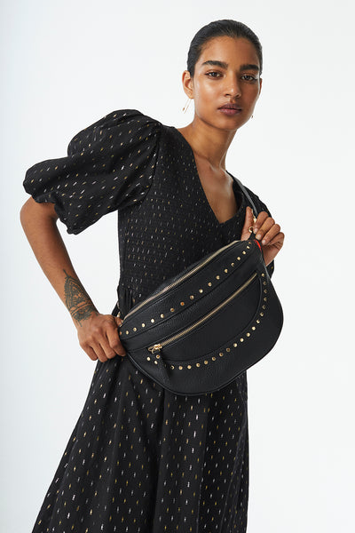 Scamp and Dude Black Studded Bum Bag | Model wearing black studded bum bag across shoulder with black dress 