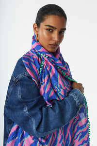 Scamp and Dude Pink with Blue and Green Tiger Charity Super Scarf | Model wearing pink and blue scarf and denim jacket looking at camera