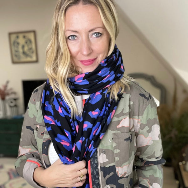 Scamp and Dude Black, Blue and Pink Leopard Print Scarf | Blonde woman wearing camouflage print jacket and black and pink scarf  