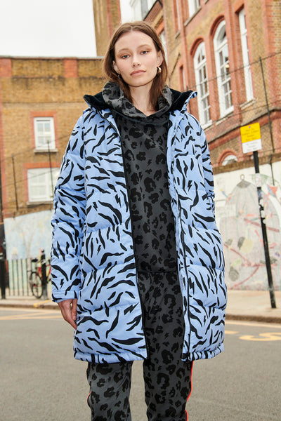 Scamp and Dude Blue with Black Zebra Puffer Coat | Model wearing blue zebra print coat with grey leopard print tracksuit