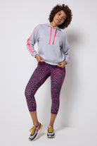 Scamp and Dude Grey with Pink Leopard Ray 7/8 Length Active Leggings | Model wearing a grey hoodie with a pair of grey and pink leopard ray leggings. Worn with trainers.