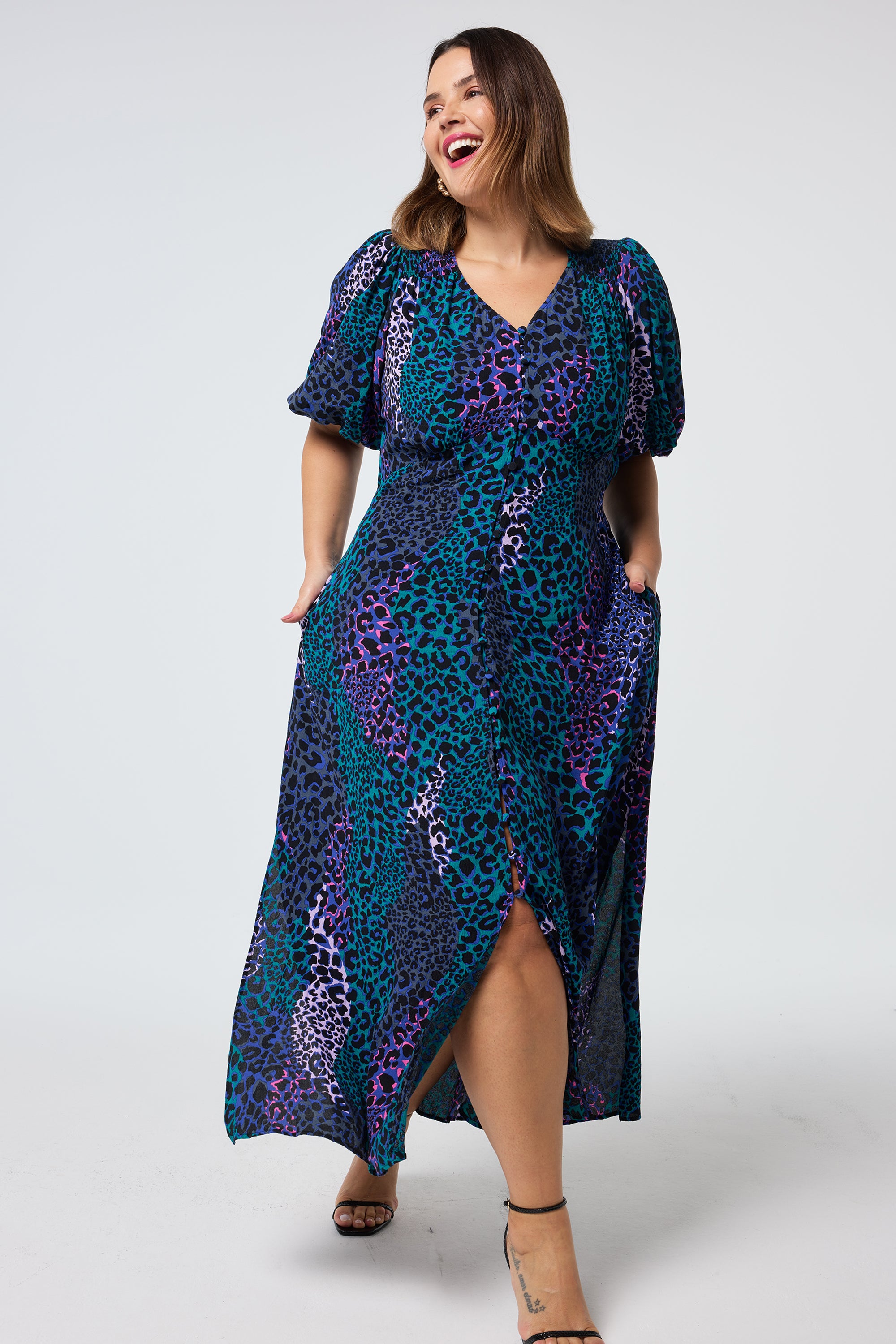 Scamp and Dude Blue with Green Spliced Leopard Puff Sleeve Midi Tea Dress | Model wearing a blue puff sleeve midi tea dress in a spliced print paired with black heels.
