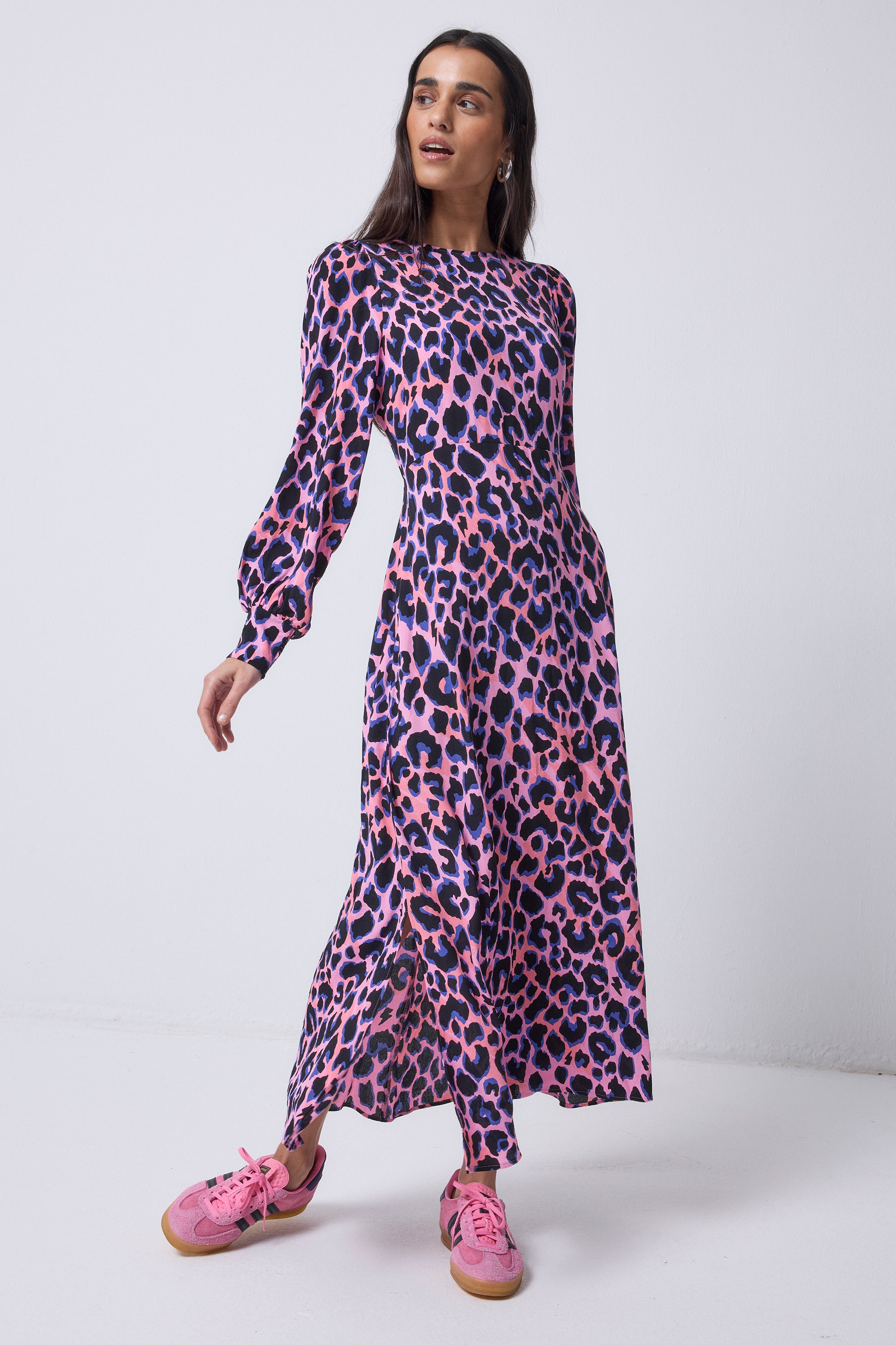 Scamp and Dude Pink with Blue and Black Shadow Leopard Blouson Sleeve Midi Dress | Model wearing a pink long sleeve dress with blue and black shadow leopard print, paired with pink trainers.