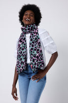 Scamp and Dude Khaki with Pink and Black Shadow Leopard Charity Super Scarf | Model wearing a white t shirt and blue jeans with a khaki and pink leopard print scarf.