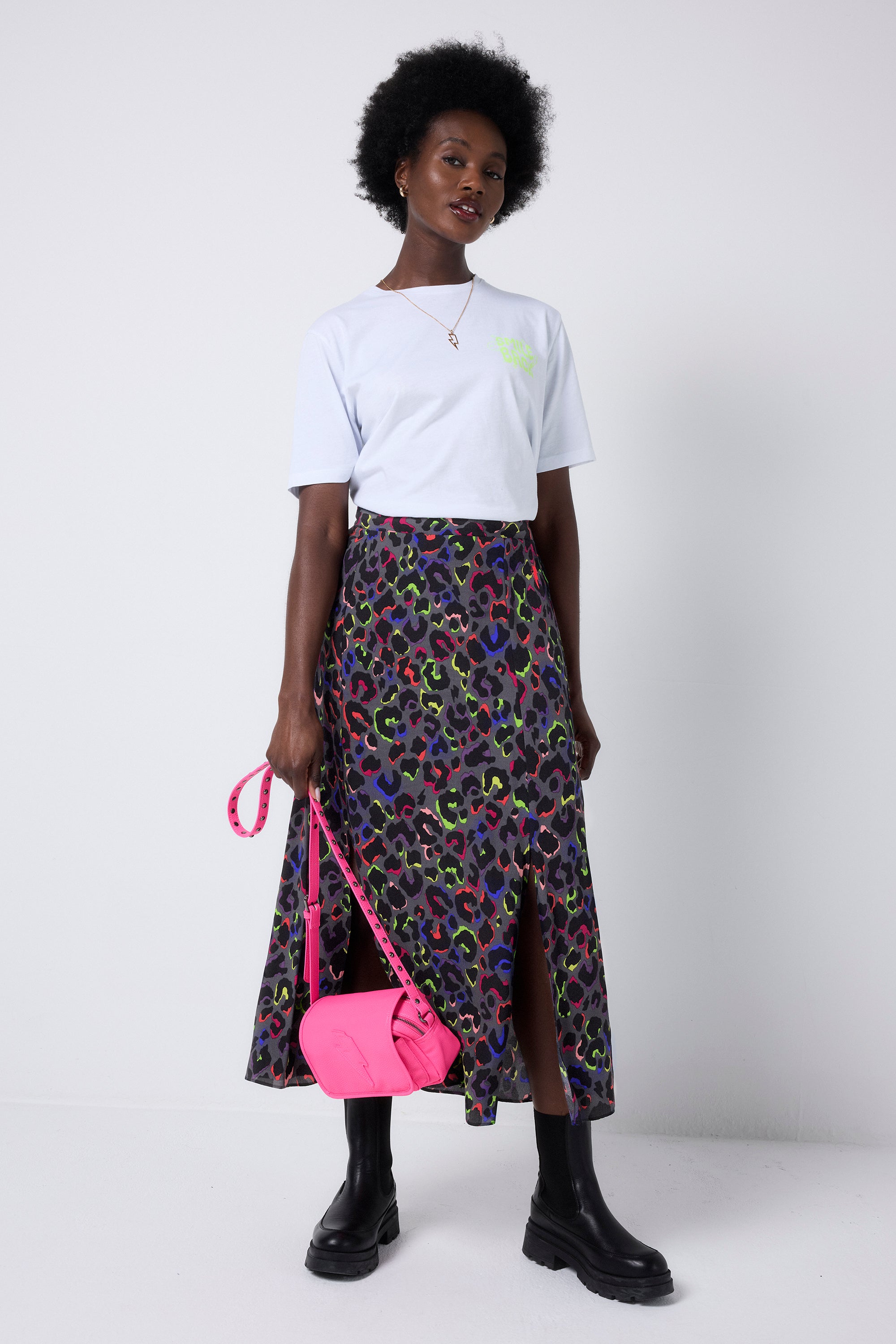 Scamp and Dude Grey with Rainbow Shadow Leopard Split Front Skirt | Model wearing a white t-shirt with a grey leopard print skirt featuring dark blue and neon pink and yellow leopard print.