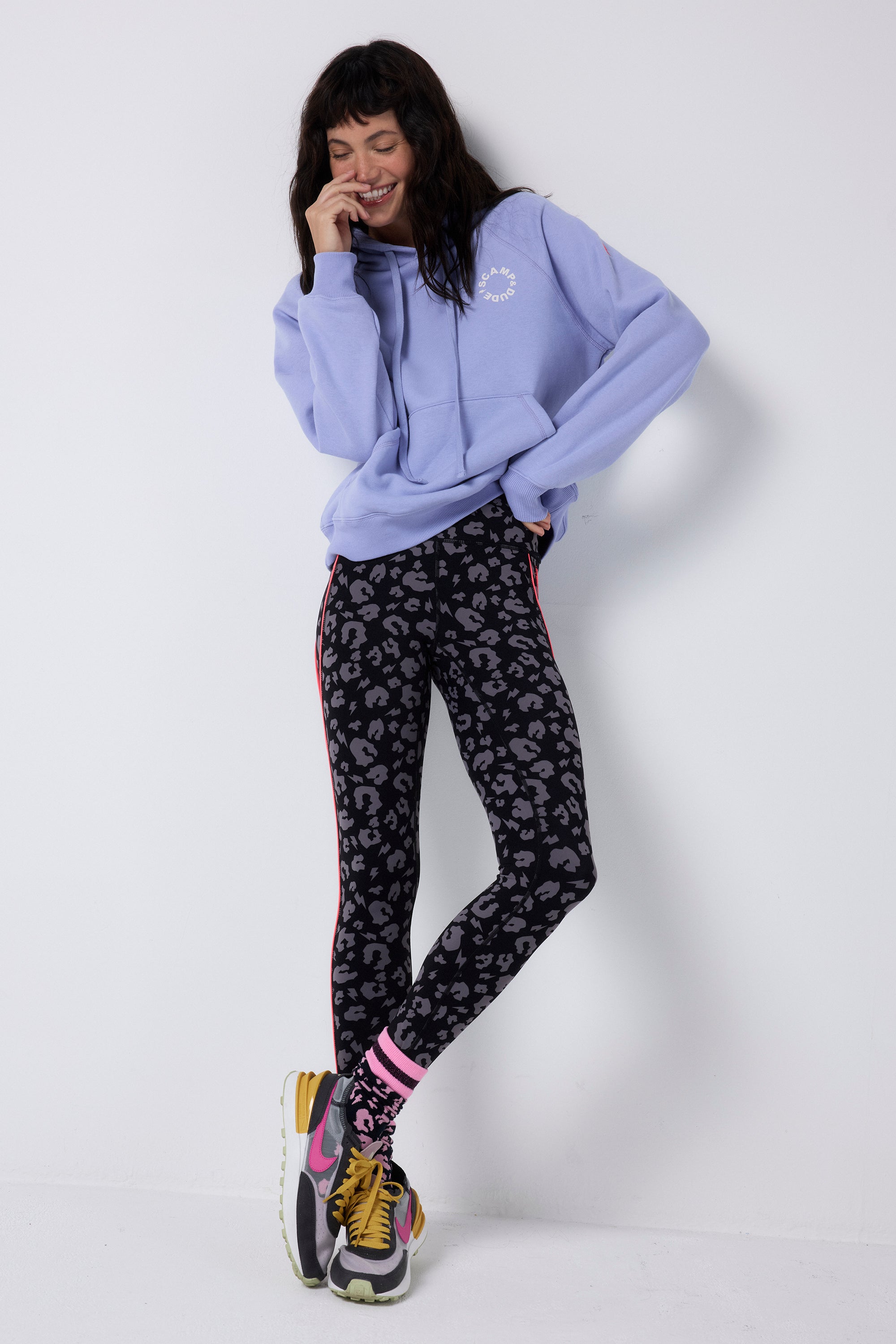 Scamp and Dude Black with Grey Leopard Full Length Active Leggings | Model wearing full length black active leggings featuring grey leopard print paired with a blue hoodie.