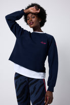 Scamp and Dude Washed Navy Cropped Sweatshirt | Model wearing navy cropped sweatshirt with a white t-shirt underneath and navy tiger print leggings.