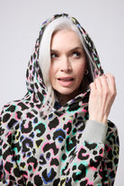 Scamp and Dude Light Grey with Rainbow Shadow Leopard Hoodie | Model wearing a grey rainbow leopard print hoodie with black joggers.