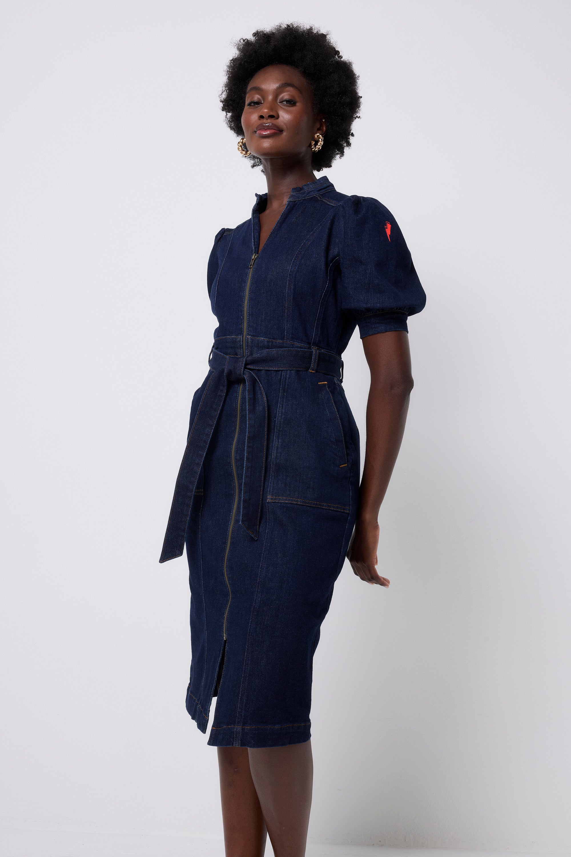 Scamp and Dude Rinse Wash Zip Detail Denim Dress | Model wearing a dark blue denim dress with a tie waist detail and zip front.