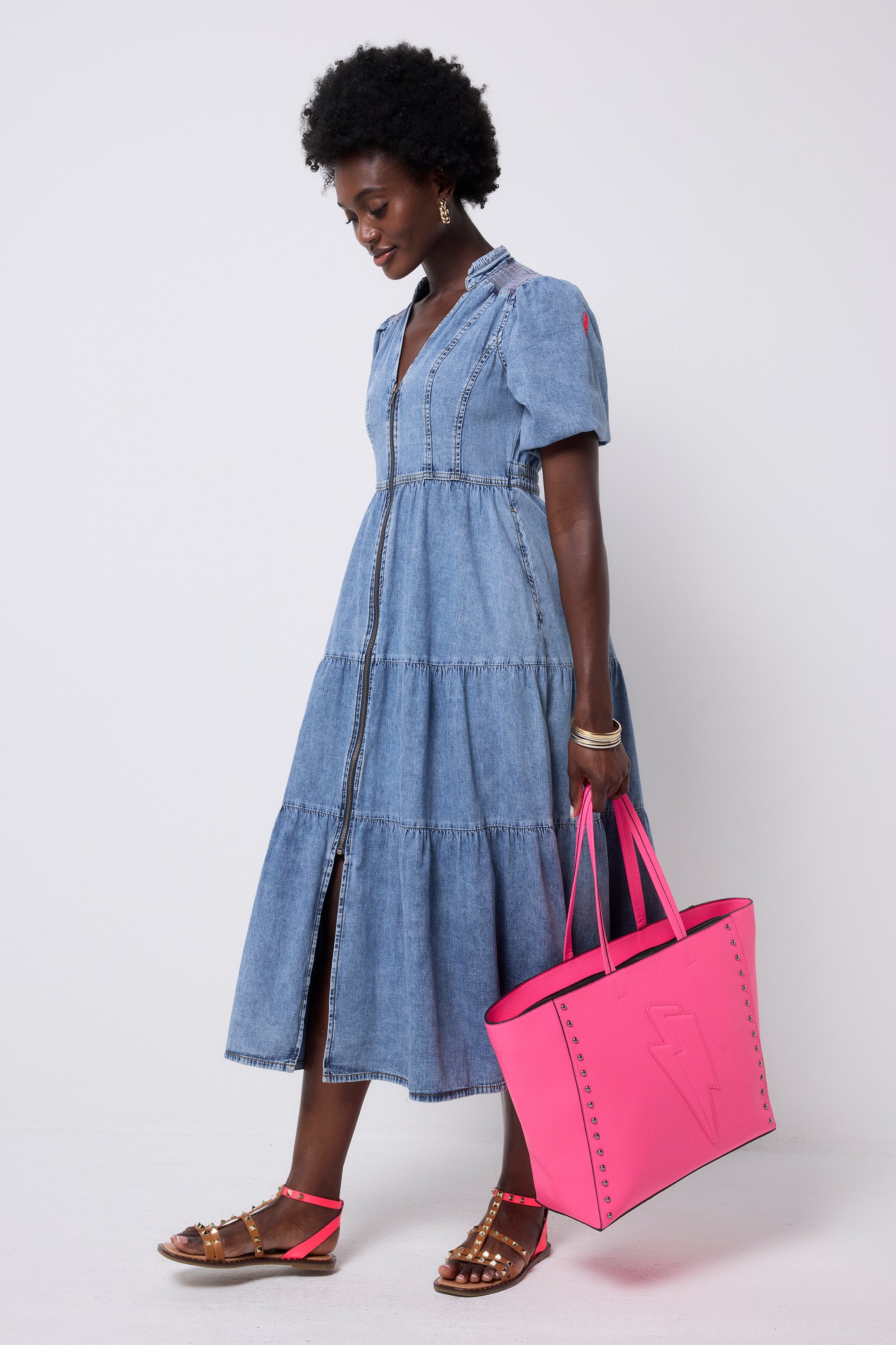Scamp and Dude Pale Indigo Zip Detail Tiered Midi Denim Dress | Model wearing a pale wash denim dress with a zip through front and tiered skirt.