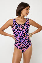 Scamp and Dude Pink with Blue and Black Shadow Leopard Scallop Edge Swimsuit | Model wearing pink scallop edge swimsuit with blue and black all over leopard print.
