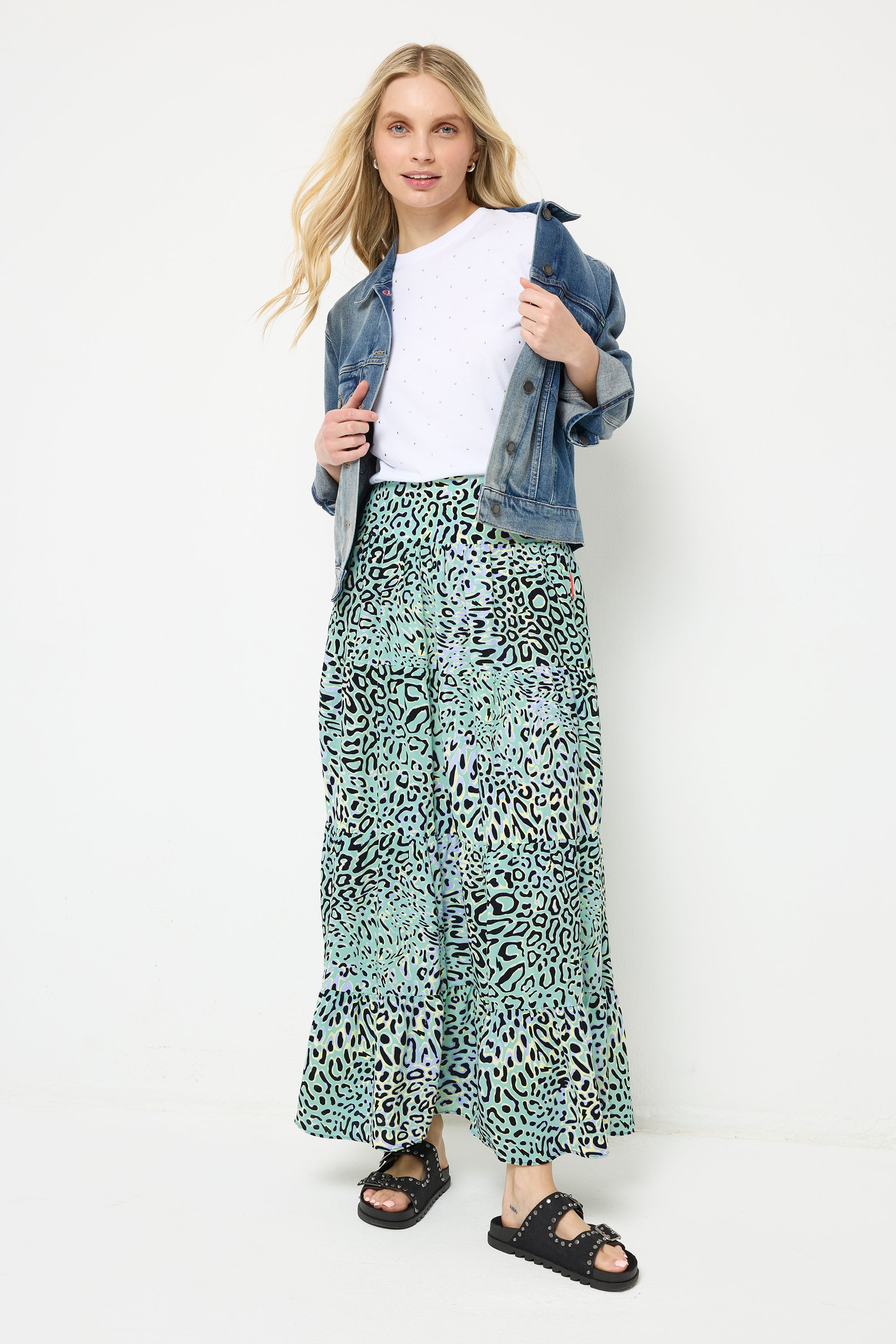 Scamp and Dude Yellow with Green Leopard Ray Maxi Skirt | Model with blonde hair wearing a green and yellow maxi skirt with a white t-shirt and blue denim jacket.