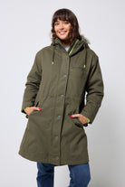 Scamp and Dude Khaki Parka | Model wearing a khaki parka jacket with blue jeans and a grey sweatshirt.