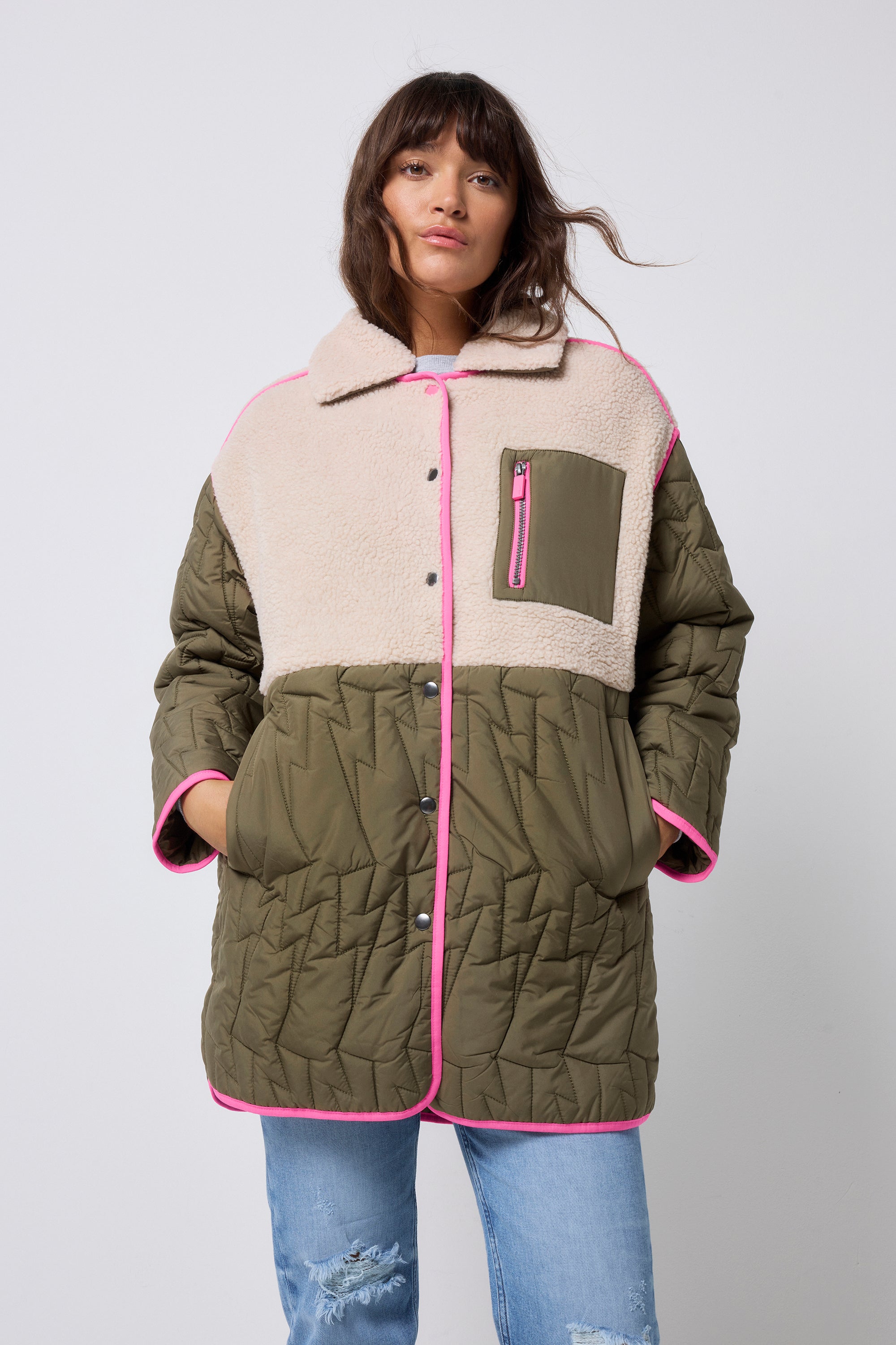 Scamp and Dude Quilted Khaki Lightning Bolt with Borg Coat | Model wearing khaki borg coat with grey love sweatshirt and distressed jeans.