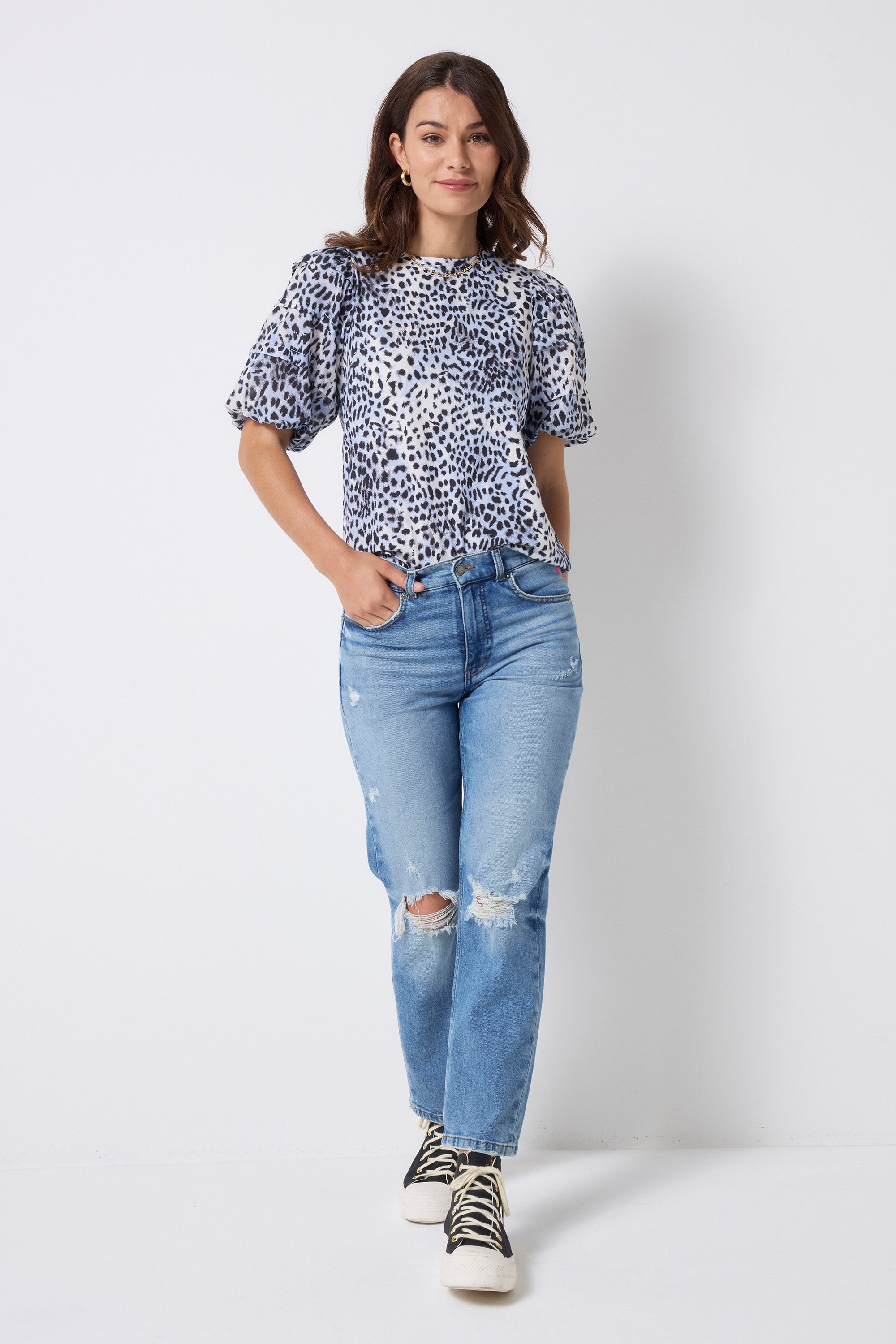 Scamp and Dude Authentic Light Indigo Distressed Straight Leg Jeans | Model wearing distressed blue denim jeans with a white and blue cheetah print t-shirt.