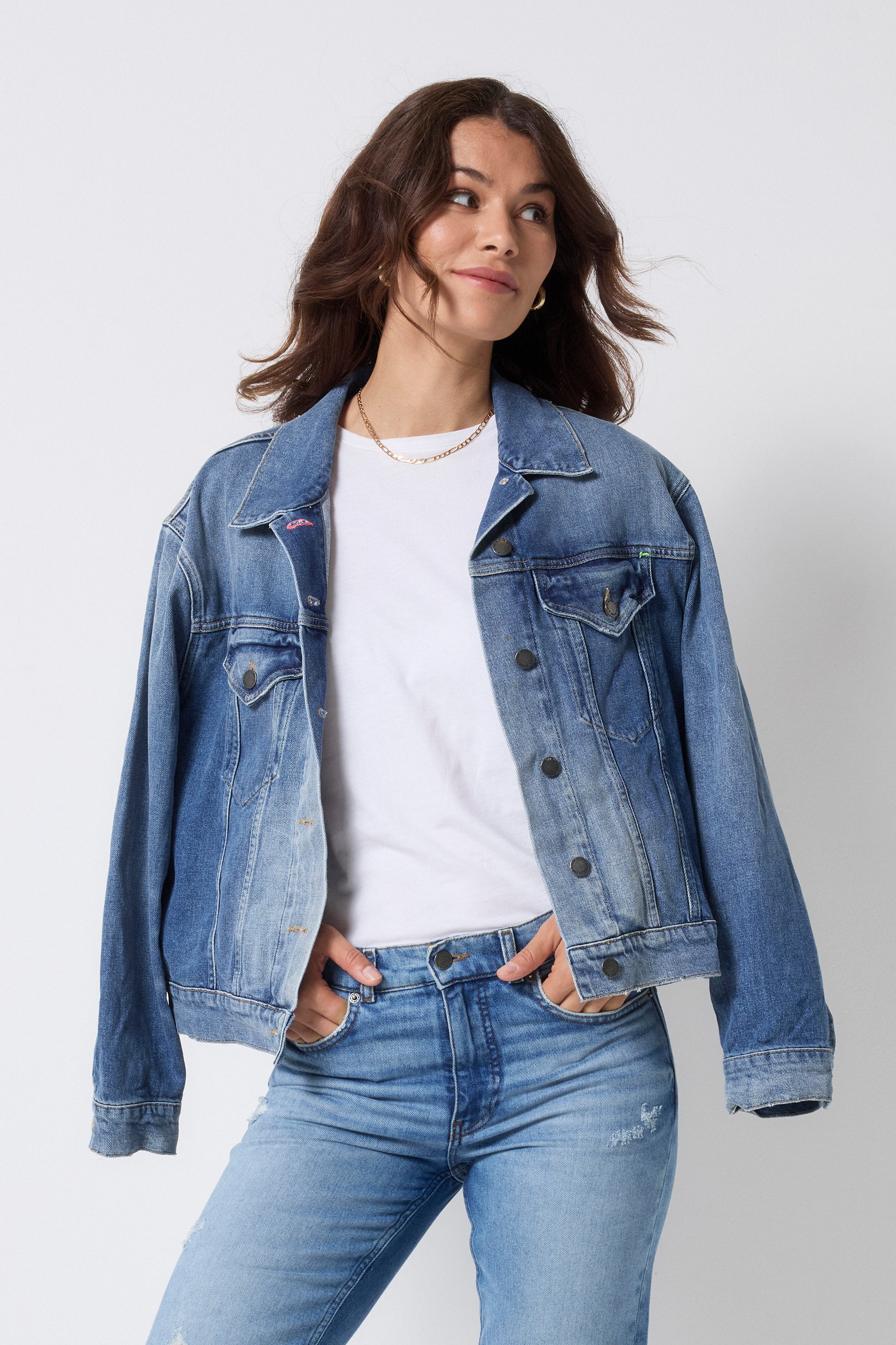 Scamp and Dude Indigo Blue Trucker Denim Jacket | Model wearing a white t-shirt with a pair of blue jeans and a blue denim jacket.