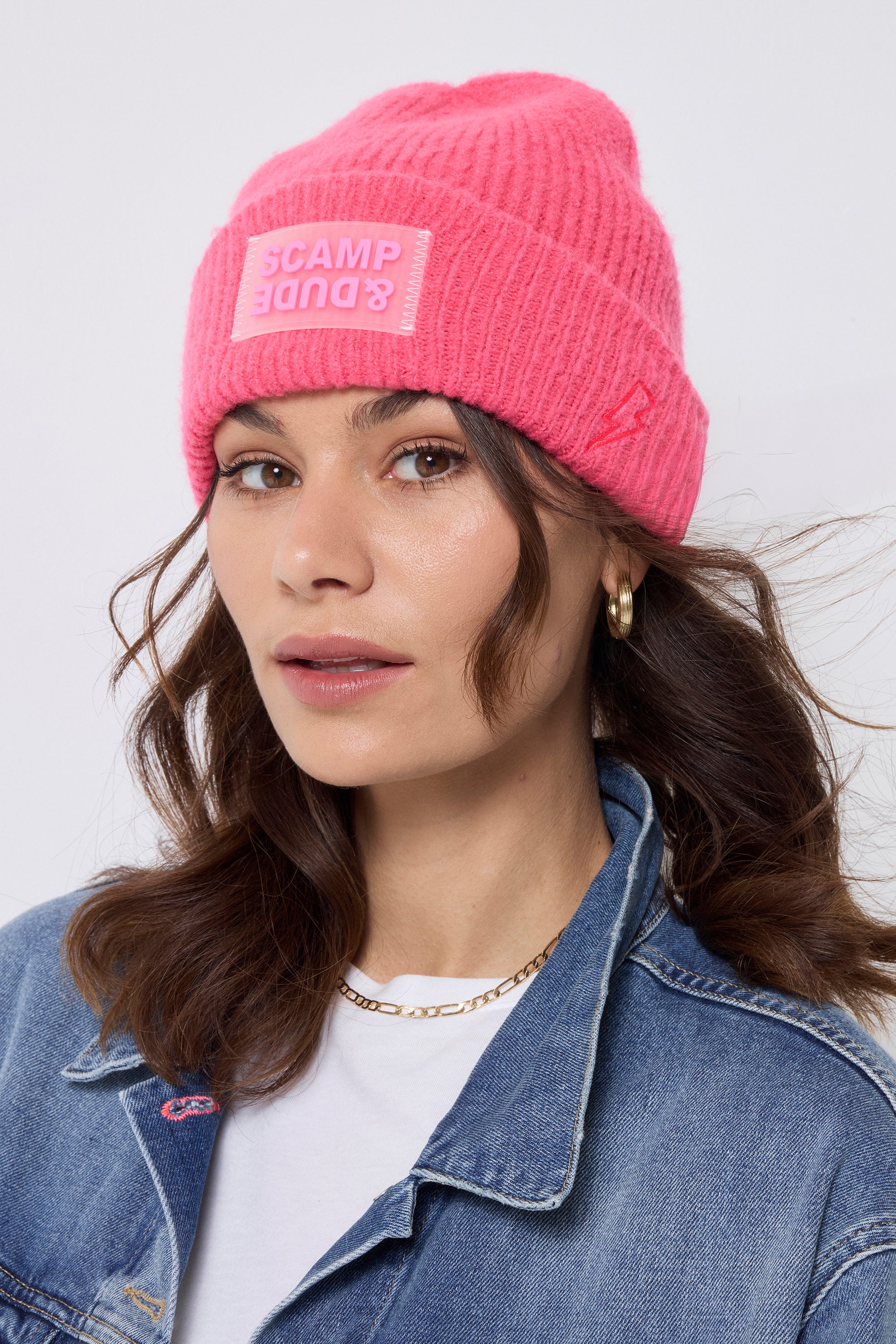 Scamp and Dude Neon Pink Beanie | Model wearing a white t-shirt and denim jacket. Worn with a neon pink beanie.