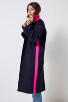Scamp and Dude Navy with Neon Pink Wool Blend Coat | Model wearing a navy wool blend coat featuring neon pink details with blue jeans.