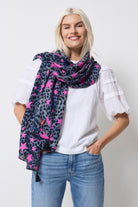 Scamp and Dude Navy with Pink Star Cheetah Charity Super Scarf | Model wearing a white t-shirt with a pair of light blue jeans and a navy with pink star cheetah print super scarf.