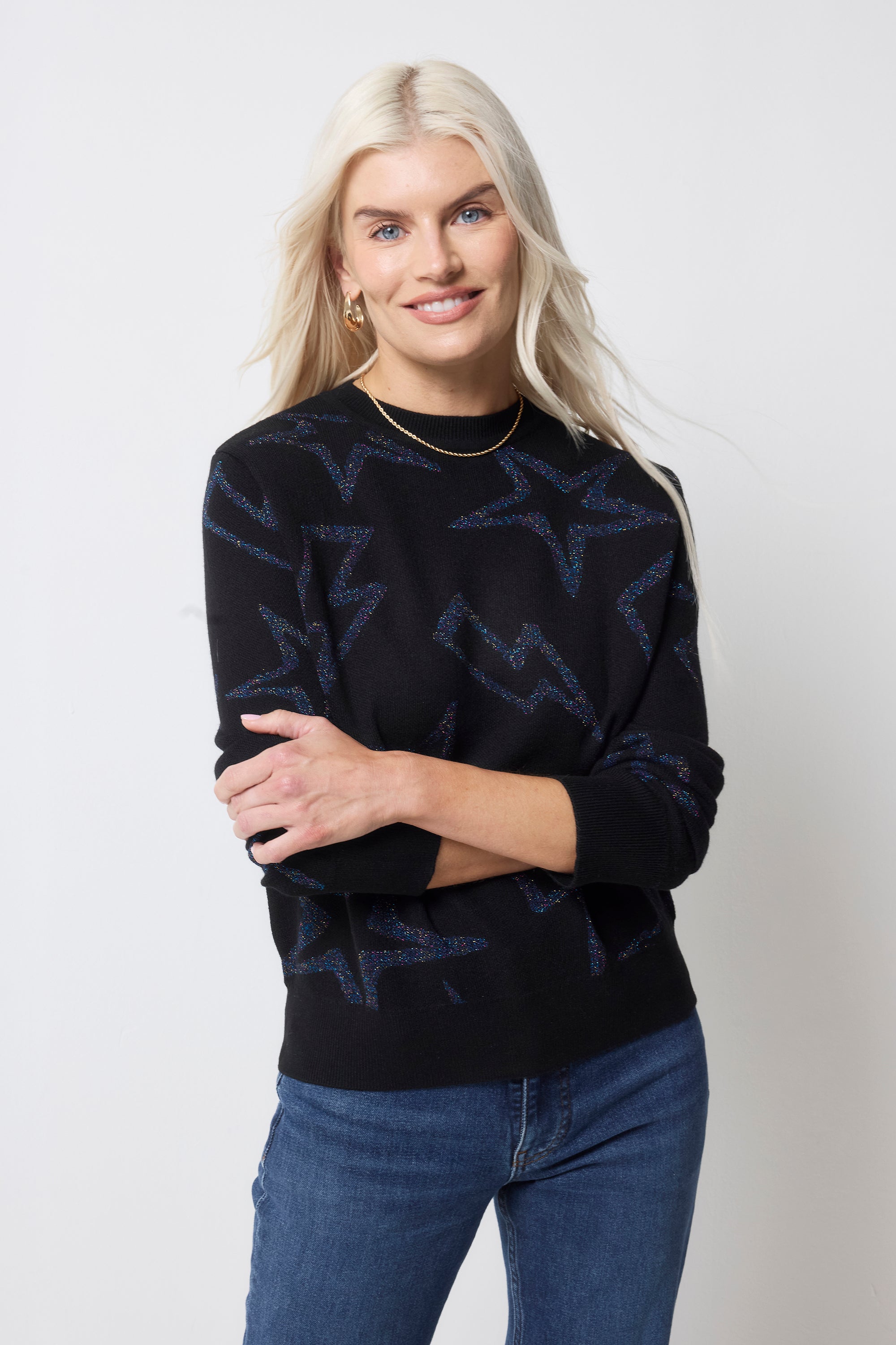 Scamp and Dude Black with Metallic Rainbow Star and Lightning Bolt Lurex Knit Jumper | Model wearing dark navy jumper with dark blue jeans.