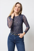 Scamp and Dude Blue with Black Cheetah Print Mesh Top | Model wearing a dark blue long sleeve mesh top with cheetah print and dark blue jeans.