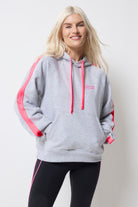 Scamp and Dude Light Grey Marl with Pink Colourblock Relaxed Hoodie | Model wearing a light grey hoodie with pink drawstrings and stripe down the sleeves. Worn with black leggings.