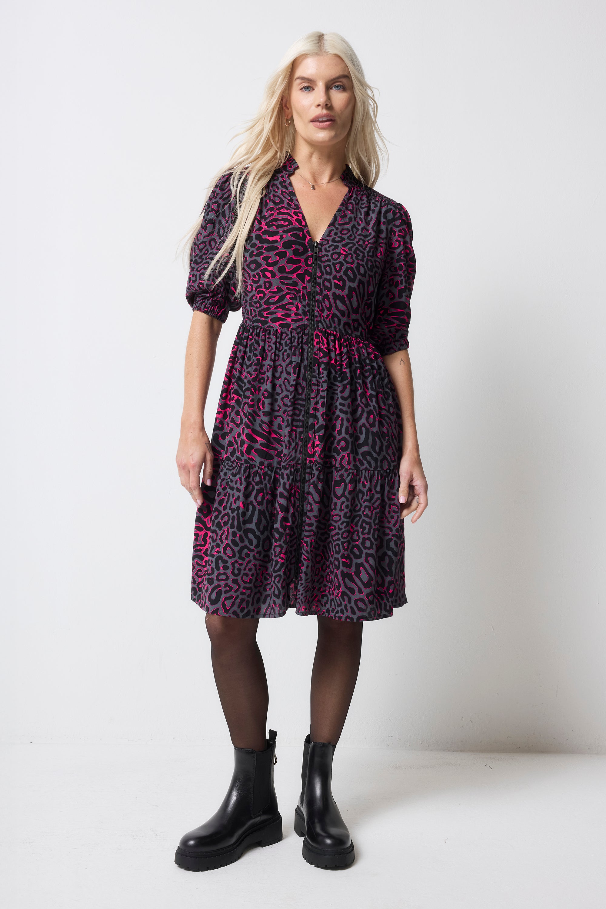 Scamp and Dude Grey with Pink Leopard Ray Zip Detail Tiered Short Dress | Model wearing short zip front grey dress with pink leopard ray print. Worn with tights and black boots.