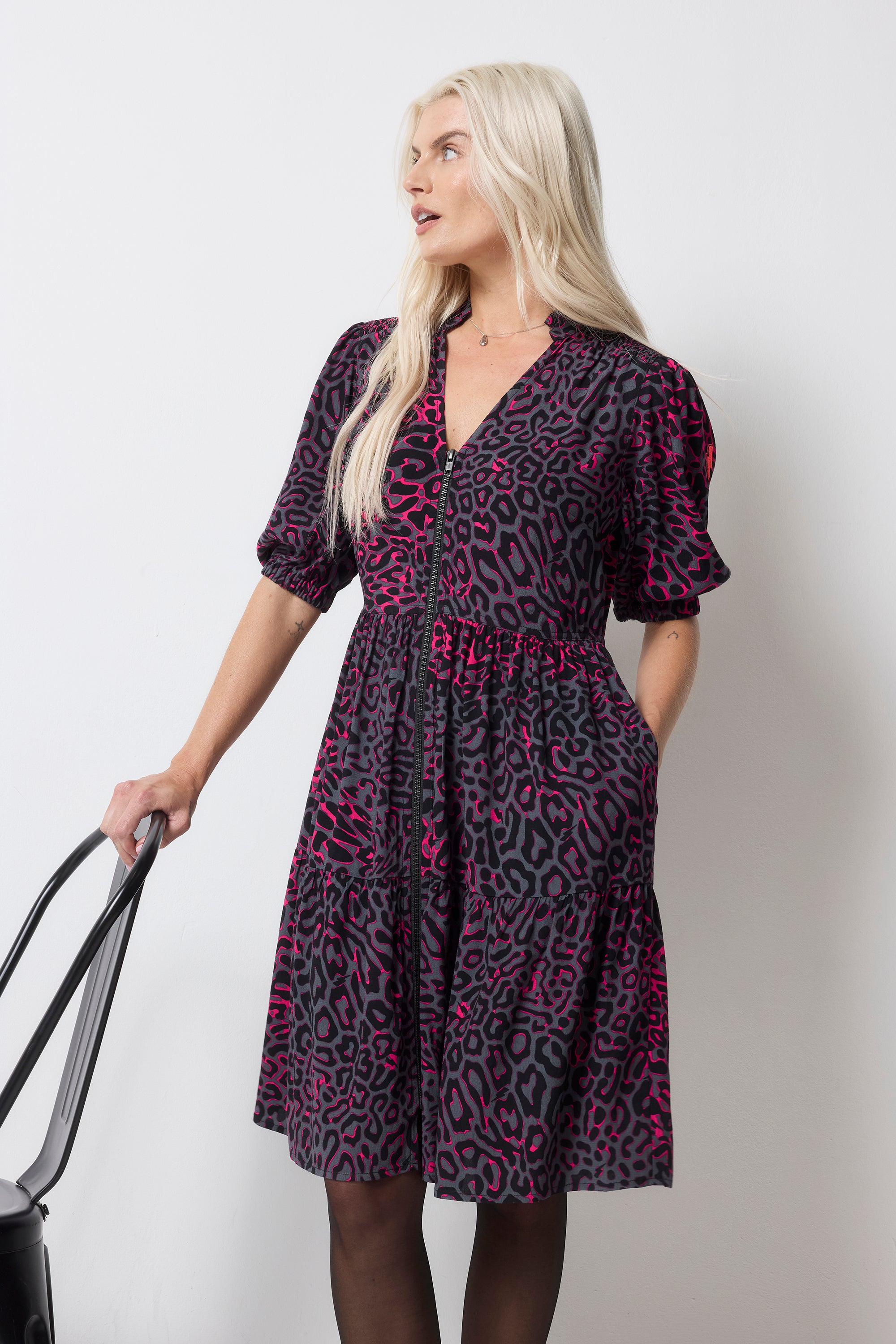 Scamp and Dude Grey with Pink Leopard Ray Zip Detail Tiered Short Dress | Model wearing short zip front grey dress with pink leopard ray print. Worn with tights and black boots.