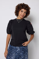 Scamp and Dude Black Pintuck Sleeve T-Shirt | Model wearing a navy cheetah print midi skirt with a black pintuck sleeve t shirt.