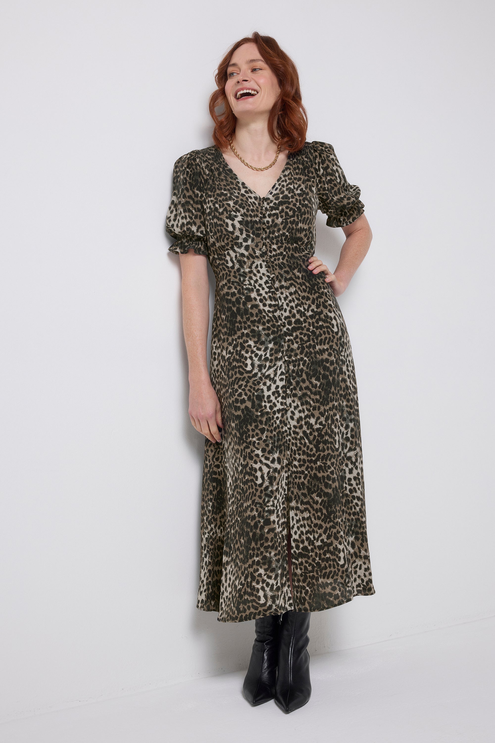 Scamp and Dude Khaki Cheetah Flute Sleeve Midi Tea Dress | Model wearing a khaki cheetah flute sleeve midi tea dress with black heeled boots.