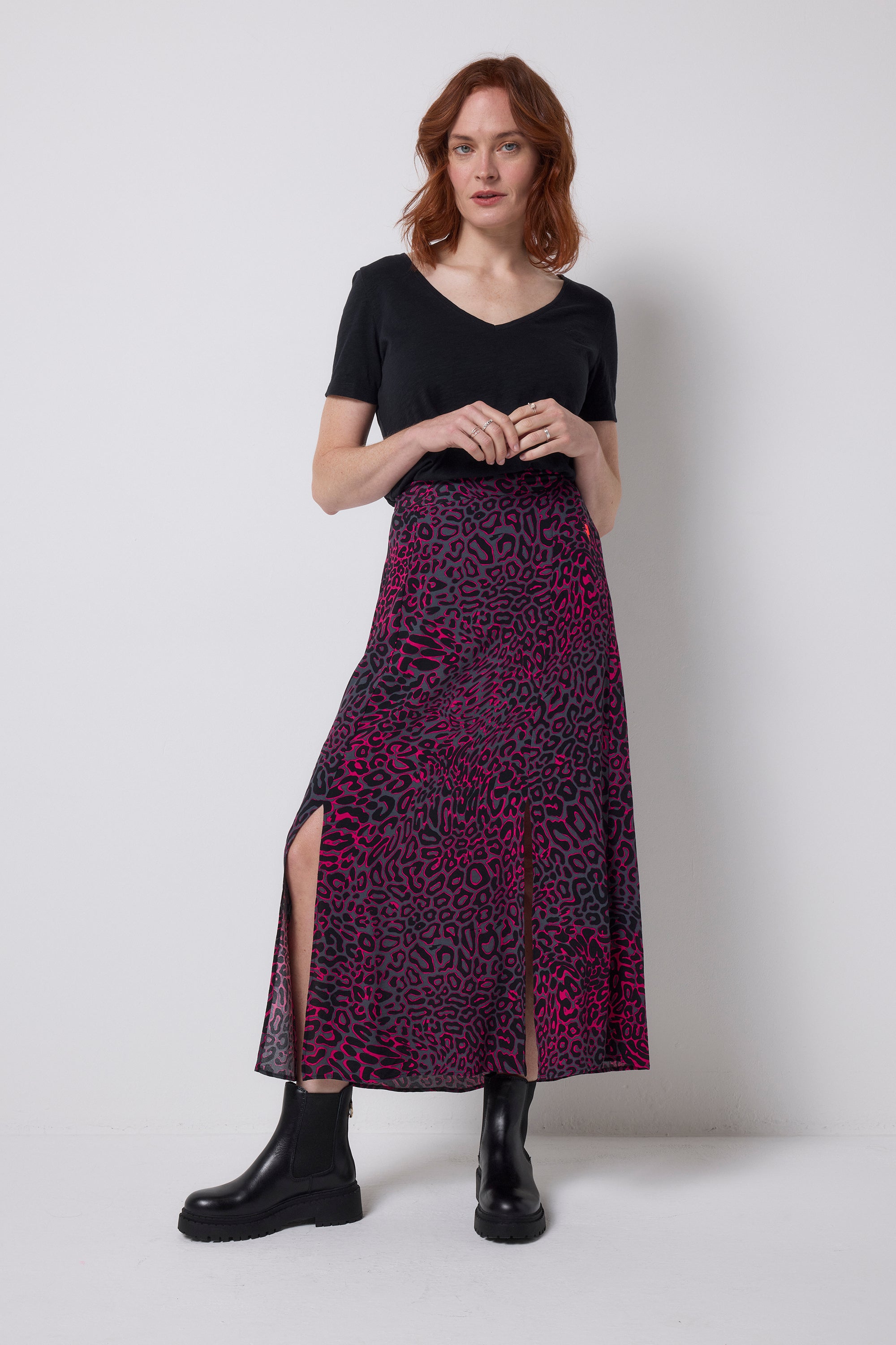 Scamp and Dude Grey with Pink Leopard Ray Split Front Skirt | Model wearing grey and pink leopard ray print midi skirt with a black v-neck t-shirt and black boots.