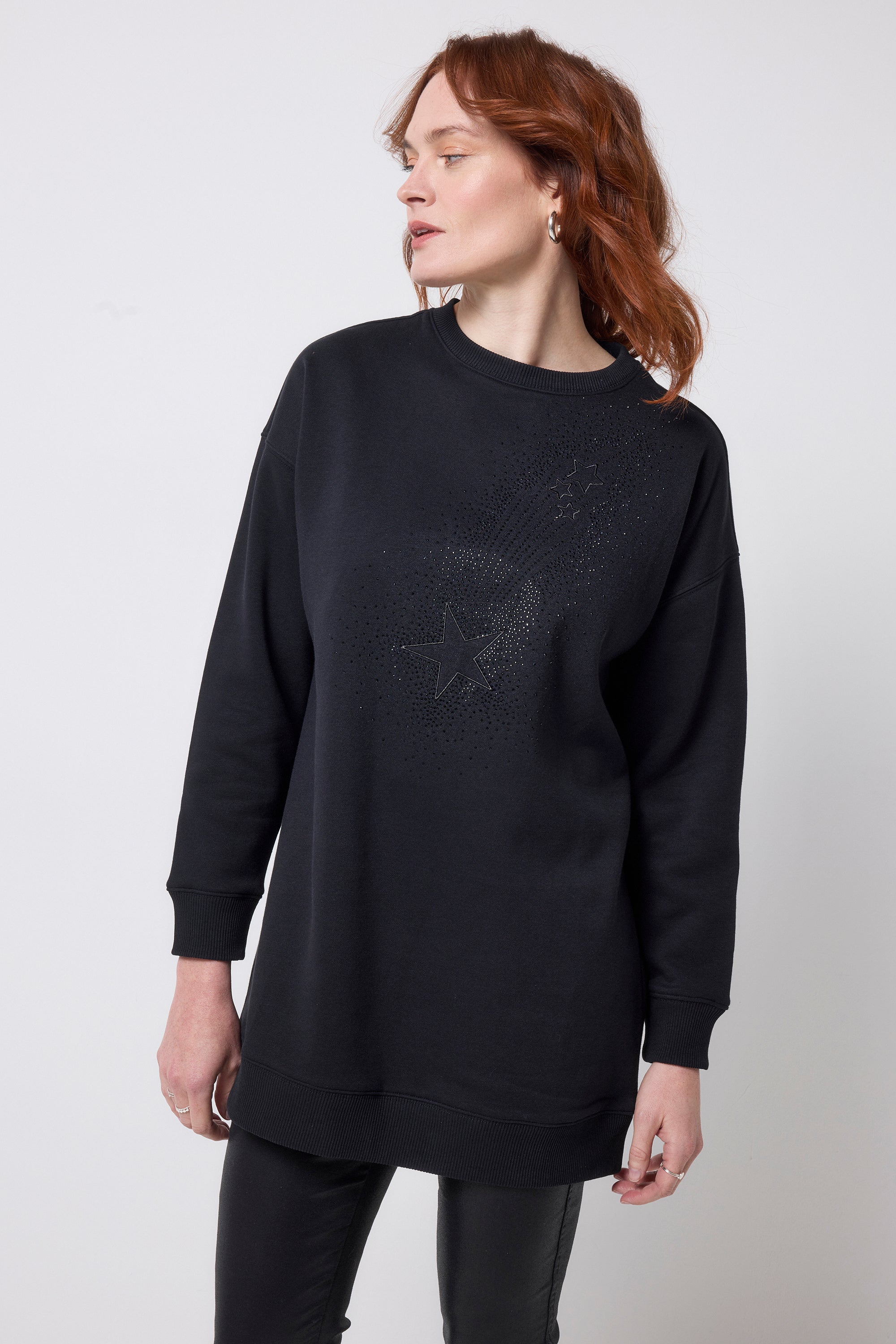 Scamp and Dude Black Embellished Shooting Star Tunic | Model wearing a black round neck tunic featuring embellished shooting star with black coated jeans.