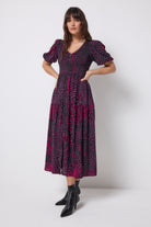 Scamp and Dude Grey with Pink Leopard Ray Shirred Zip Detail Midi Dress | Model wearing a grey with pink leopard ray print v-neck midi dress with zip front detail.