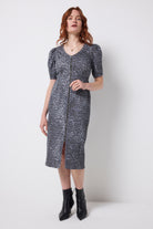 Scamp and Dude Washed Navy Wild Cheetah Denim Zip Front Midi Dress | Model wearing a washed navy cheetah print denim dress with zip front detail. Worn with black heeled boots.