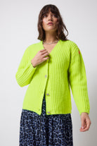 Scamp and Dude Neon Yellow Button Through Cardigan | Model wearing a navy jaguar zip front dress with a neon yellow cardigan that has diamante button detail.