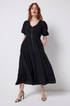 Scamp and Dude Black Shirred Zip Detail Midi Dress | Model wearing a black v-neck zip front dress with leopard print high heels.