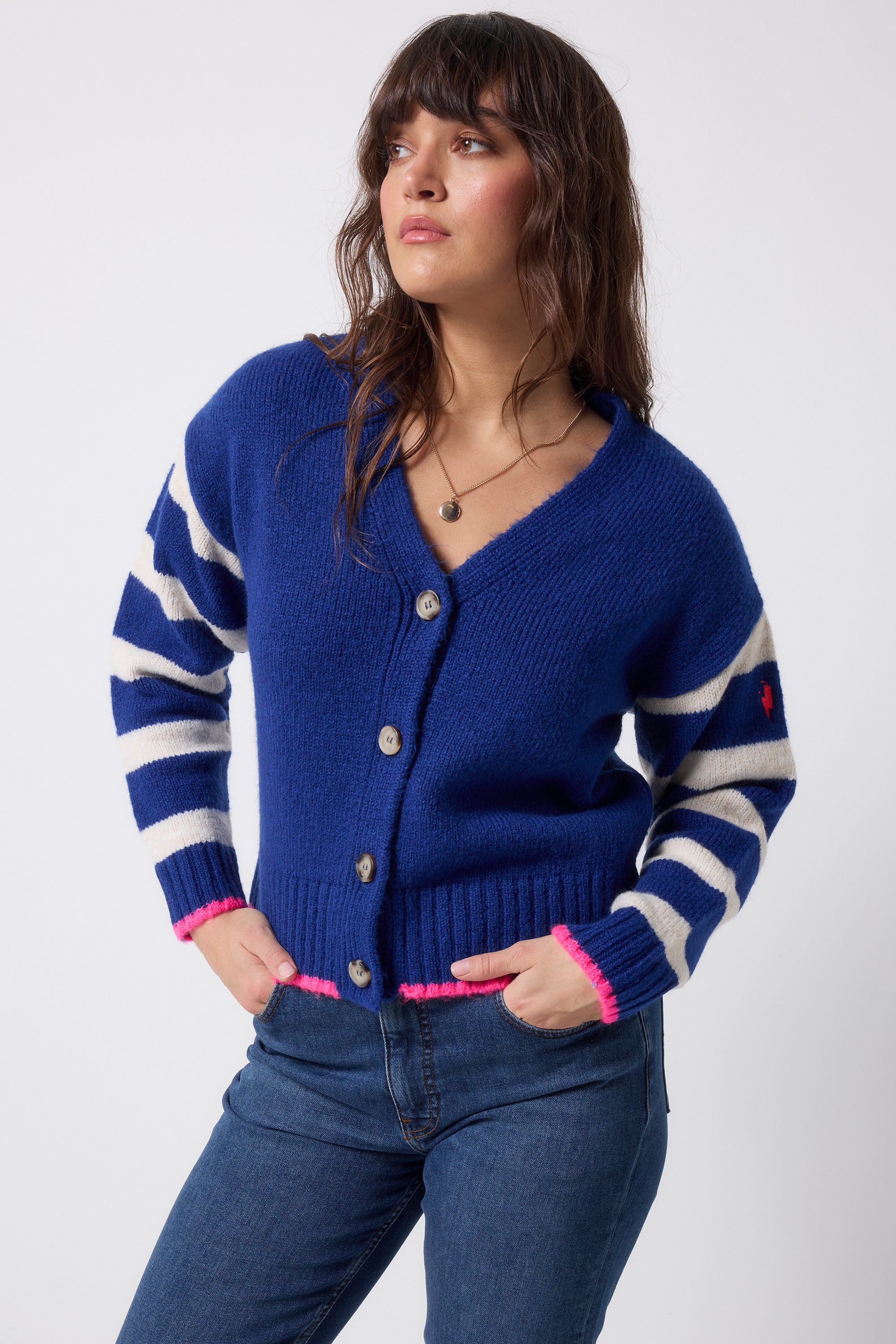 Scamp and Dude Bright Blue with Cream Stripe Cardigan | Model wearing a bright blue cardigan with cream stripe and pink detail.
