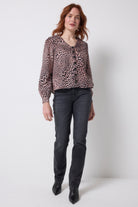 Scamp and Dude Neutral Leopard Ray Collared Blouse | Model wearing neutral leopard ray print blouse with washed black jeans and boots.