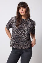 Scamp and Dude Khaki with Black Cheetah T-Shirt | Model wearing a pair of black jeans with a khaki cheetah print t-shirt.
