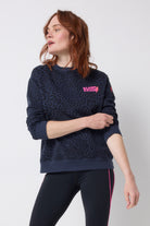 Scamp and Dude Navy with Black Leopard Ray Logo Oversized Sweatshirt | Model wearing a crew neck navy leopard ray print sweatshirt with black leggings.